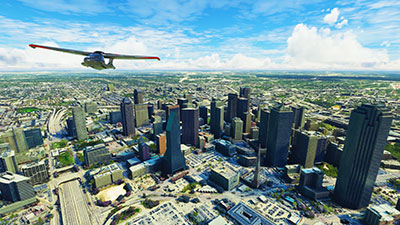 An Icon A5 aircraft flying over the city of Dallas in Microsoft Flight Simulator (MSFS) 2020 release after installing this freeware mod.