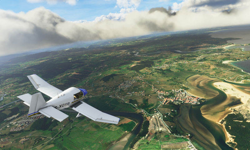 Aircraft flying over estuary and coastline.