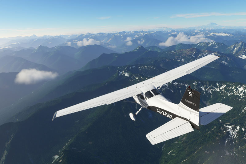 Cessna flying over mountains.