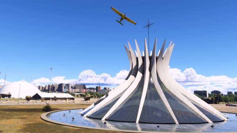 Light aircraft flying high over landmark in MSFS2024.