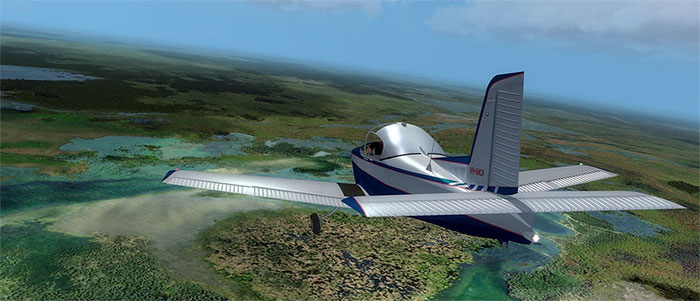 The Victa Airtourer flying over swamp land.