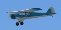 Basic blue Piper J-3 Cub in flight.