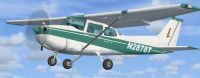 Green And White Cessna 172SP in flight.