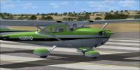 Green Cessna Skyhawk 172 on runway.