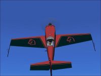 Red Knight Extra 300S in flight.